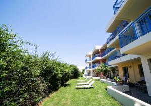 a row of chairs sitting in the grass next to a building at Elpida Village in Istro