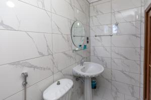 a white bathroom with a sink and a mirror at Black Pearly Hotel in Trabzon