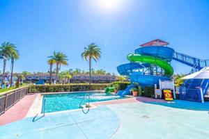 a pool with a water slide at a resort at TVPM-2678TWithRO townhouse in Orlando