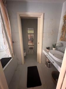 a bathroom with a tub and a sink and a toilet at Verona Luxury Flats , Piazza Erbe with balcony on main square in Verona +69 photos