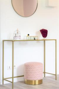 a console table with a round mirror and a stool at LE GLAMOUR *STUDIO *PARKING PRIVE* *WIFI*CALME* in Lourdes