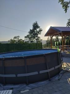 a swimming pool in a backyard with a gazebo at TRI KOLIBE in Bor