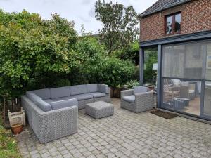 a patio with a couch and two chairs at Gîte 7ici in Blaimont +31 photos