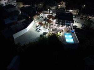 an overhead view of a house with a pool at night at Hotel Deyanira in Gorno Dryanovo