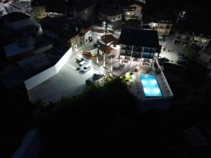 an overhead view of a house with a pool at night at Hotel Deyanira in Gorno Dryanovo