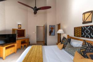a bedroom with a bed and a flat screen tv at Kruger Park Lodge Unit No 308 with private pool - NYALA LODGE in Hazyview