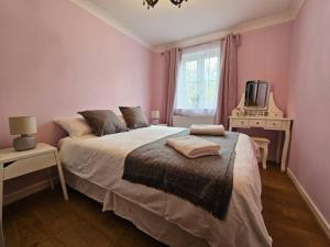 a bedroom with a bed and a tv and a window at Lovely Flat close to Shepherd's Bush in London