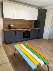 a kitchen with a colorful bench in the middle of it at Era Home in Murg