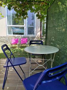 einen Tisch und Stühle sowie einen Tisch und Stühle in der Unterkunft Blue summer villa in Sinemorets
