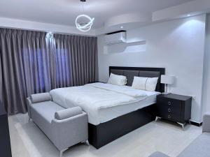 una camera con un grande letto e una sedia di Saraya Al Joude a Irbid