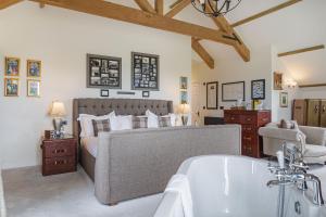 a bedroom with a large bed and a bath tub at The Jamaica Inn, Bodmin, Cornwall in Bolventor