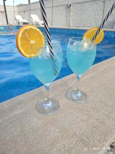 two glasses of water with an orange slice on a table at Villa Jelena in Trebinje