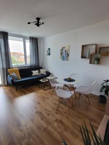 a living room with a couch and a table and chairs at SiSi Art in Varna City