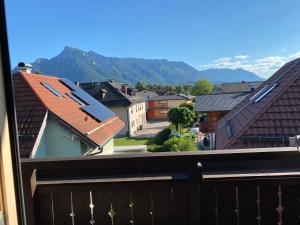 a view from a balcony of a town with mountains at Salzburg-Loft im Stadtteil Leopoldskron-Moos 120qm mit Balkon & Untersbergblick in Salzburg