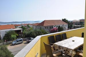 a balcony with a table and chairs and a view of a street at Apartment Lara in Vodice