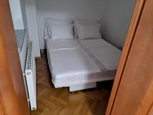 a small bedroom with a bed in a small room at Eko Eko in Rijeka