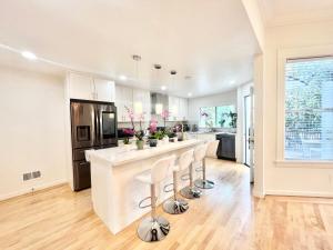 a kitchen with a large island with bar stools at New Modern Spacious 4bdr Home by Golden Gate Park in San Francisco