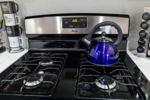 a blue tea kettle sitting on top of a stove at San Diego's Cozy Gem in San Diego