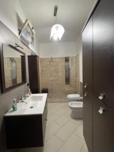 a bathroom with a sink and a toilet at Casa Vacanze Al Vesuvio in Trecase +12 photos