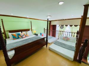 a bedroom with two beds and a window at Cebu City Huge Lofts by P&J in Cebu City