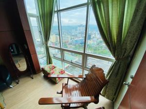 a room with a chair and a large window at Cebu City Huge Lofts by P&J in Cebu City