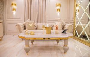a living room with a table and a couch at Alexandras Palace in Bradford