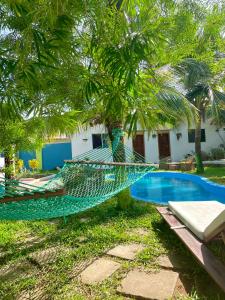 a hammock in front of a swimming pool at Green's Nungwi in Nungwi