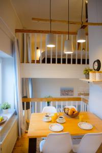 a dining room with a table and chairs and a bunk bed at Brise in Westermarkelsdorf