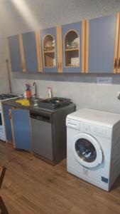 a kitchen with a washing machine and a sink at Queens house in Oświęcim