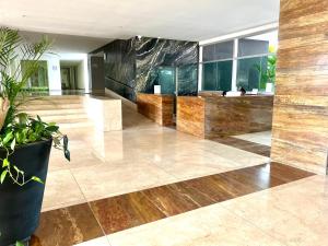 a lobby with wooden floors and plants in a building at Frente al mar Morros Epic 323 in Cartagena de Indias