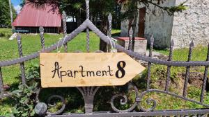 a sign on a fence that reads experiment eight at Gorska Vila Apartments in Žabljak