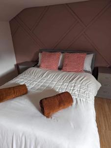 a bed with two brown pillows on it at Holiday home in City Centre in Liverpool