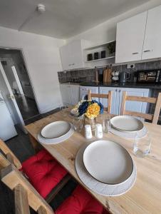 a wooden table with plates on it in a kitchen at Holiday home in City Centre in Liverpool