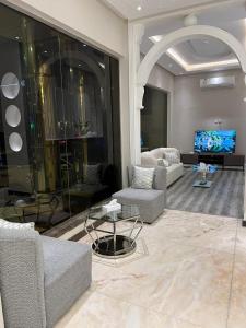 uma grande sala de estar com sofás e uma televisão em ايار للشقق المخدومه em Riyadh