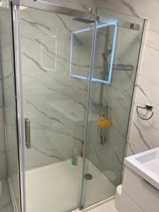 a shower with a glass door in a bathroom at Garma in Slatine