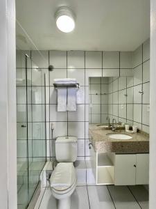 a bathroom with a toilet and a sink at Flat Gran Lençóis in Barreirinhas