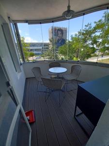 a balcony with a table and chairs in a building at Apartament Provence in Burgas