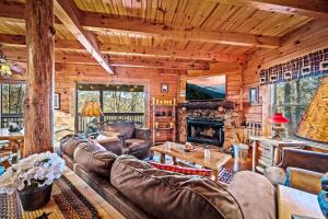 a living room with leather furniture and a fireplace at CABIN in a GATED RESORT with SEASONAL RESORT POOL in Pigeon Forge