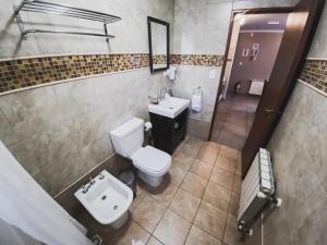 an overhead view of a bathroom with a toilet and sink at La Posta Apart in Ushuaia