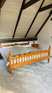 a wooden bed in a room with a ceiling at Domek Leśny Reset in Studzienice