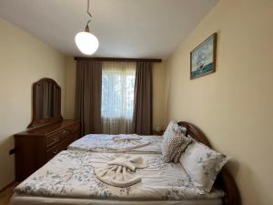 a bedroom with a bed with towels on it at Lugano Couples Quiet Apt w Free Street Parking in Sofia