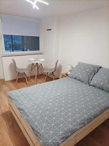 1 dormitorio con 1 cama, 2 sillas y ventana en Pensjonat na Wzgórzu, en Solina