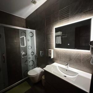 a bathroom with a sink and a toilet and a mirror at La Vie Boutique Hotel in Wadi Musa +24 photos
