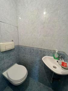 a bathroom with a toilet and a sink at Lugano Couples Quiet Apt w Free Street Parking in Sofia +8 photos