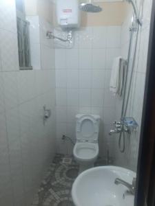 a small bathroom with a toilet and a sink at Starnford Hotel in Njara
