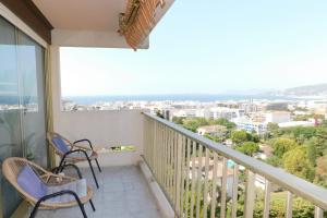 a balcony with chairs and a view of the ocean at Charming T2 Eden Park with swimming pool private parking in Juan-les-Pins
