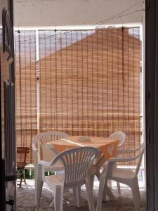 a table and chairs in front of a large window at Apartman Šarac in Višegrad