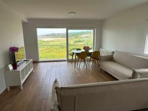 a living room with a couch and a table at Mar de Queiruga: 01 As Seiras in Porto do Son