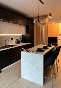 a kitchen with a island in the middle of a room at Elite Summer Suite in Năvodari