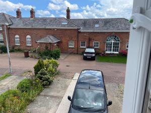 a car parked in front of a brick building at Serenity Station in Hornsea